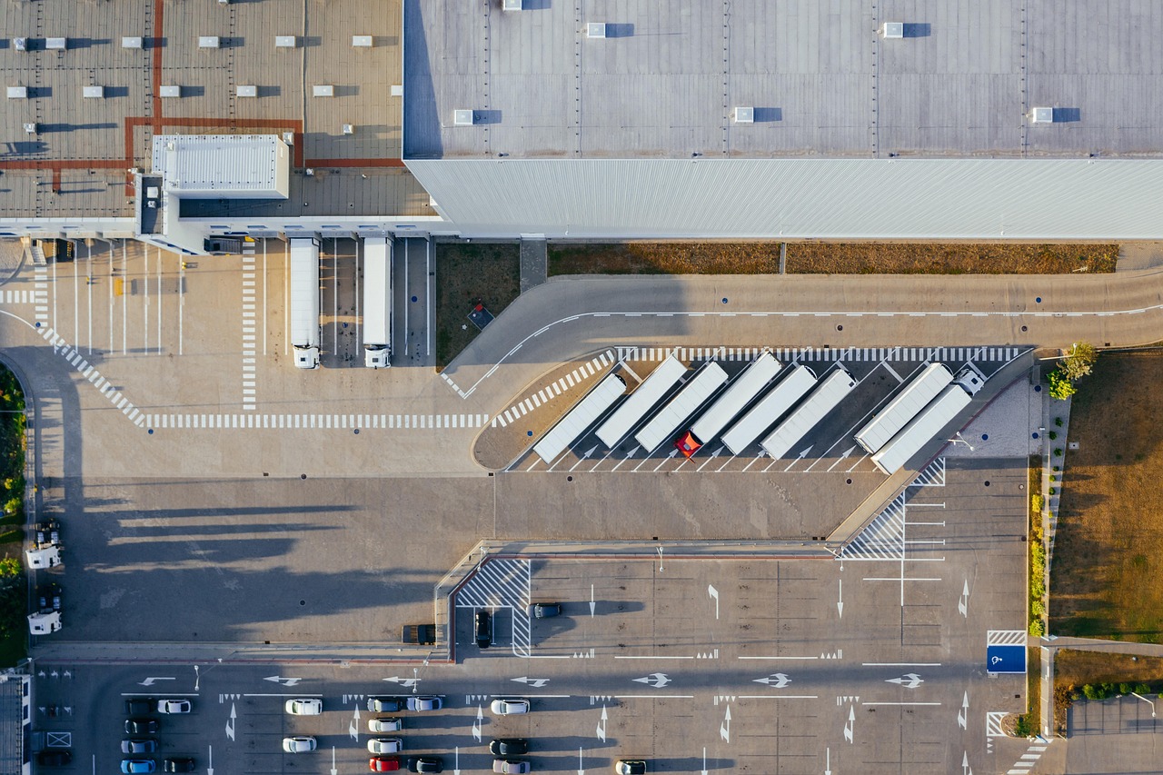 Aerial view of a distribution center with delivery trucks staged at the docks